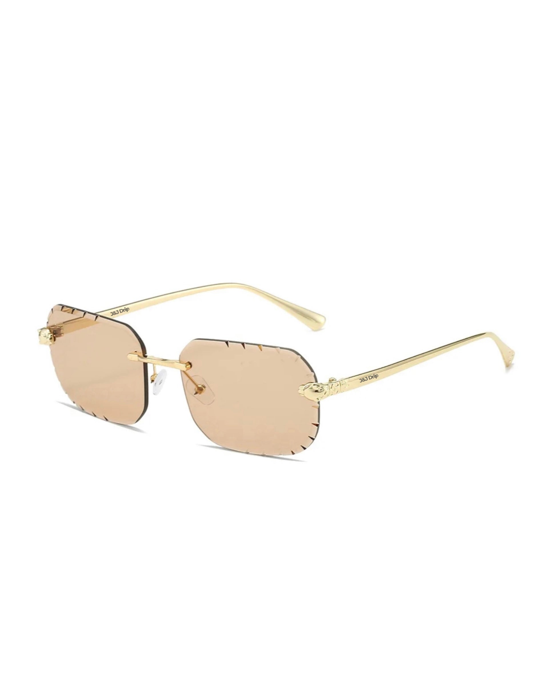 Het model Drippin Shades van J&J Drip Sunglasses, onderdeel van Always Drip Fashion, heeft een stijlvolle randloze vormgeving met verfijnde details. De prachtig gesneden randen en moderne uitstraling maken deze bril een eyecatcher. Geschikt voor zowel dames als heren, en verkrijgbaar in 9 verschillende kleuren voor een persoonlijke touch.